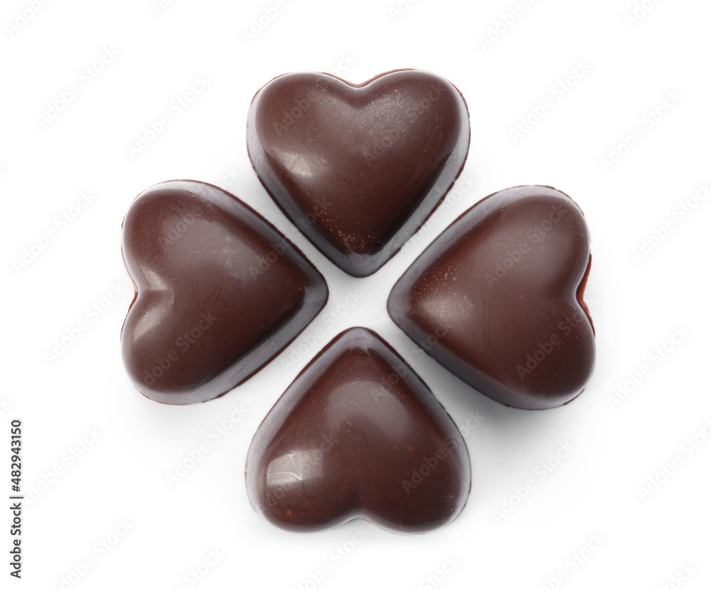 Fototapeta premium Tasty heart-shaped candies on white background