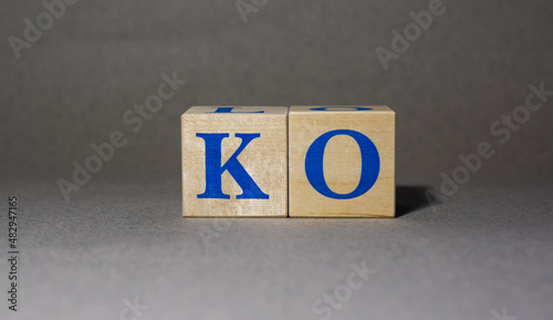 January 19, 2022. New York, USA. The stock Ticker symbol of The Coca-Cola KO, made of wooden cubes, on a gray background.