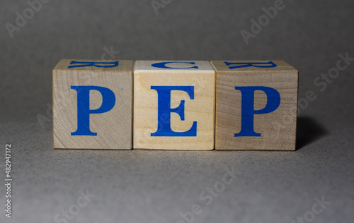 January 19, 2022. New York, USA. PepsiCo PEP Ticker symbol made of wooden cubes on a gray background. photo