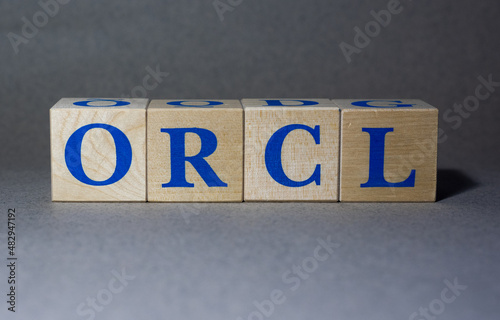 January 19, 2022. New York, USA. Exchange Ticker symbol of Oracle Corporation ORCL, made of wooden cubes, on a gray background.
