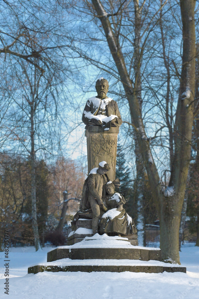 Statue of Czech composer Bedrich Smetana in Hořice. Covered with snow. Beautifule winter day.