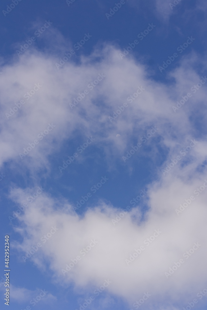 an azure blue sky with three white clouds an azure blue sky with three white clouds