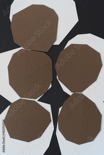 bronze and white polygonal shaped paper arranged in an abstract composition