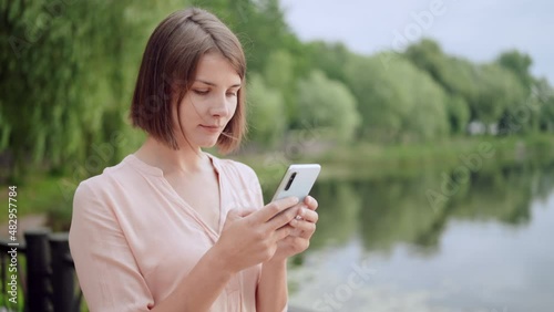 female going on the street messaging on mobile photo