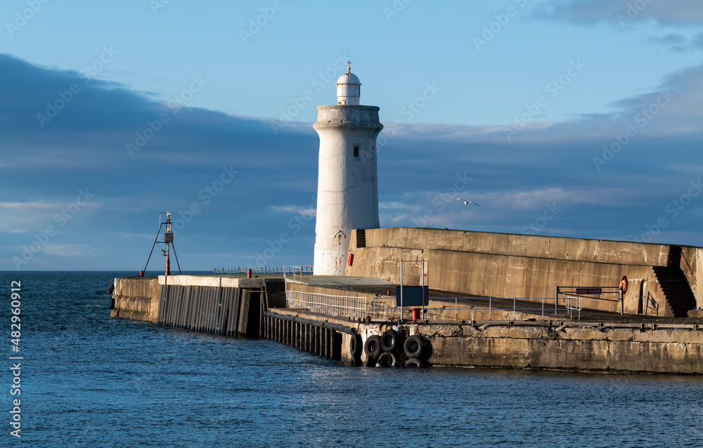 BUCKIE,MORAY, SCOTLAND - 23 JANUARY 2022: This is the sun shining on the entrance to the harbour at Buckie, Moray, Scotland on 23 January 2022.