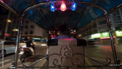 Timelapse of driving tuktuk in night Bangkok, Thailand photo