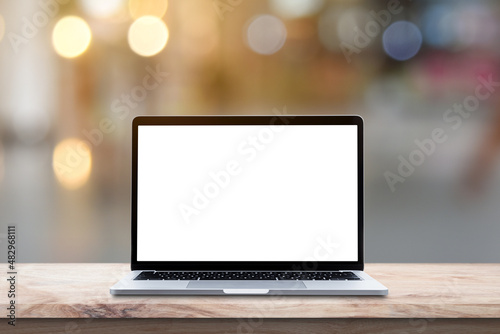 Modern Laptop computer with blank screen on wood table over blur bokeh light background.