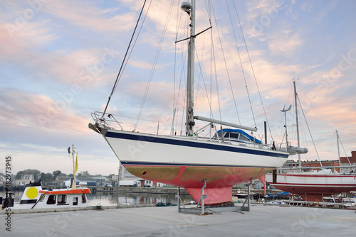 45 ft cruising sailboat standing on land in a yacht marina. Transportation, nautical vessel, repair and service, sailing, sport, recreation. tourism, leisure activity concepts