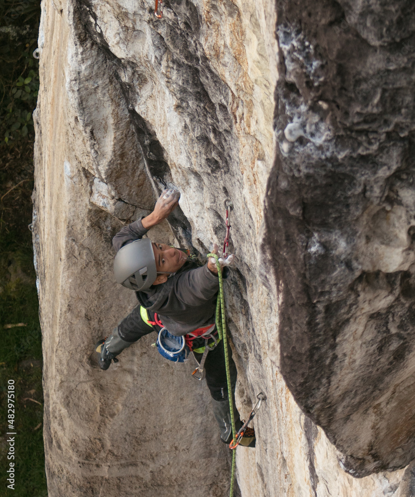 Candid shot of fit dark skinned male rock climber trying hard Candid shot of fit dark skinned male rock climber trying hard