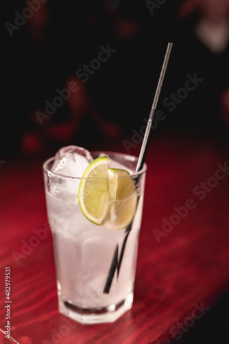 Alcoholic cocktail with lemon in a nightclub