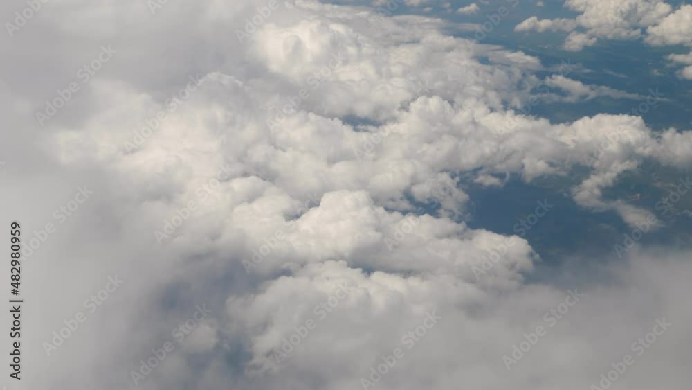 View from airplane window. Peaceful cloudscape. Light cumulus clouds in high clear blue sky View from airplane window. Peaceful cloudscape. Light cumulus clouds in high clear blue sky