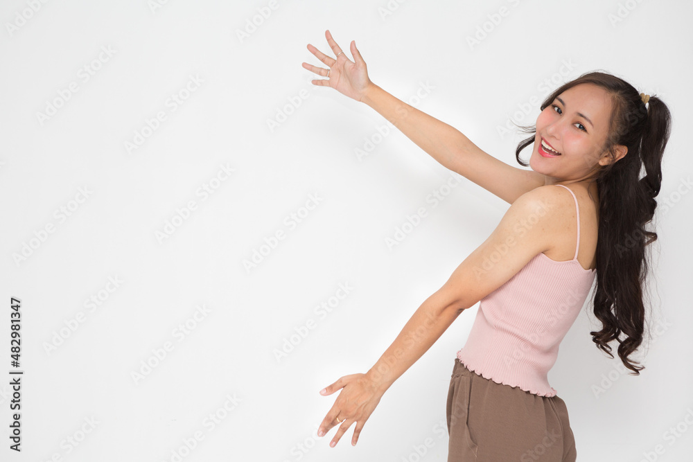 Cute Asian woman smiling and cheerful presenting something for advertising concept Cute Asian woman smiling and cheerful presenting something for advertising concept