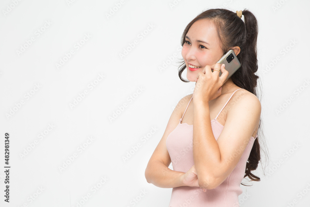 Cute Asian woman smiling and cheerful talk something on the phone for social media concept Cute Asian woman smiling and cheerful talk something on the phone for social media concept