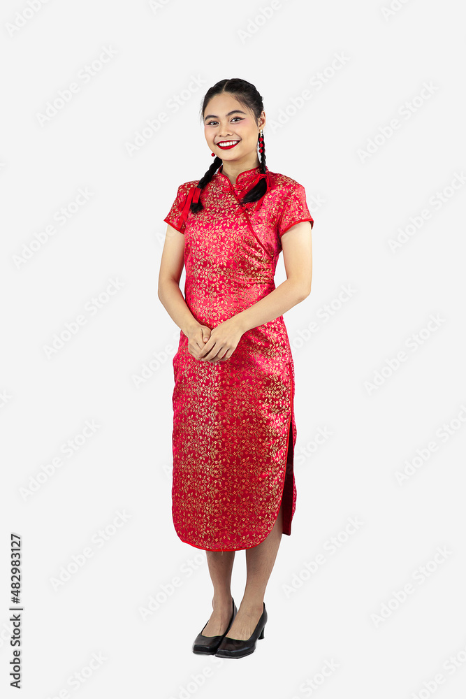 Asian girl in cheongsam standing isolated on white background. Chinese new year concept. Asian girl in cheongsam standing isolated on white background. Chinese new year concept.