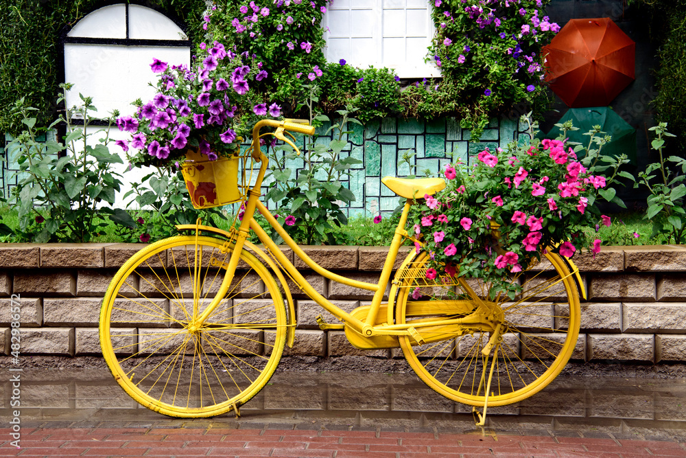 Yellow bicycle with flowers in the Miracle Garden Dubai
