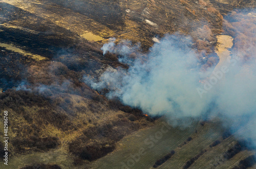 Agriculture fires during spring. Aerial view of some field fires in order to clean the fields for agriculture planting. Farming industry.  Air pollution. © Dragoș Asaftei
