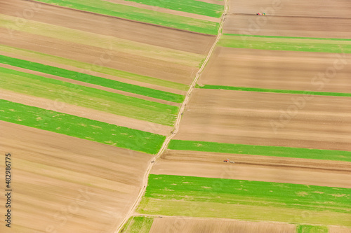 Agriculture fields in spring, aerial view in a sunny day. Agriculture and farming industry.