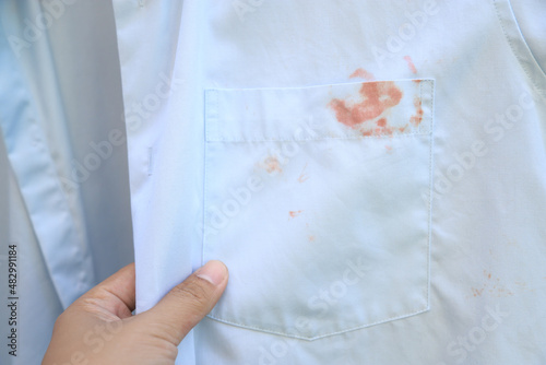 Принти на полотні Hand showing dirty cosmetic stain on white shirt from unexpected accident