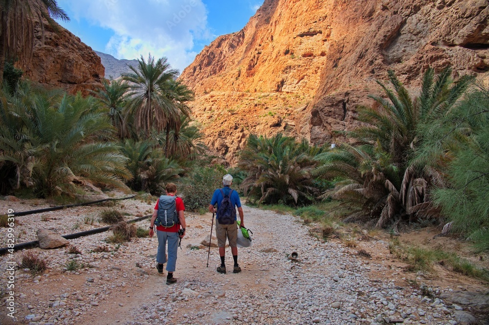 Senior couple hiking along Wadi Shab in Oman