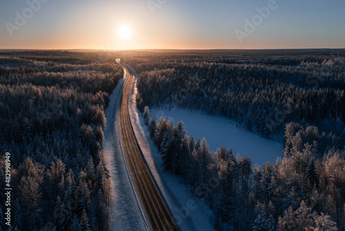 Aerial view of a road in taiga landscape in Finland.