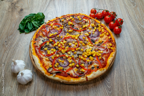 pizza with prosciutto, onion, red pepper, corn, tomato sauce, mushroom and cheese