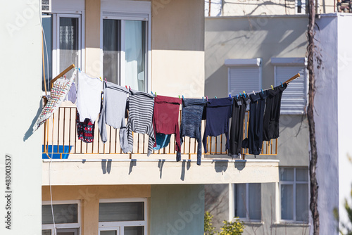 A white house in an turkish  city, laundry is drying on a rope photo
