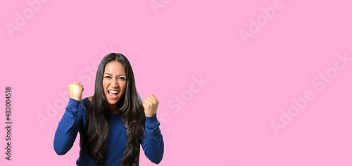 Enthusiastic young woman throwing a temper tantrum balling her fists