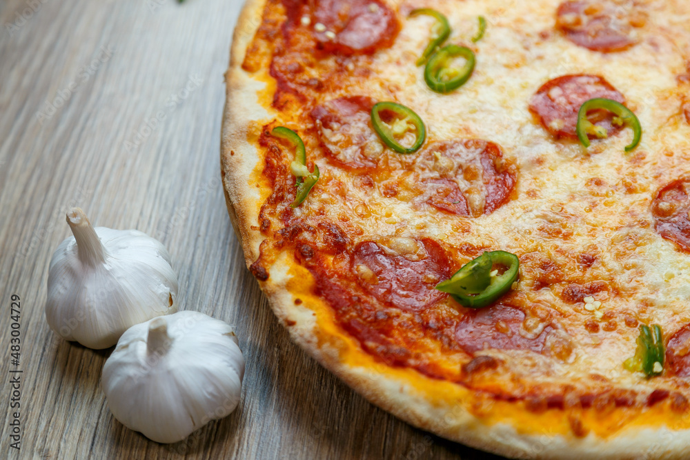 pizza with salami, mozzarella, green hot pepper