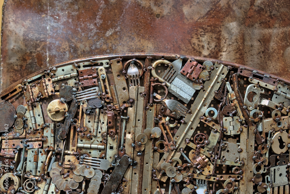 Grunge background, rusty metal details. gears, forks, fittings, wires and other old products are welded to uneven sheets of iron. Perfect for backgrounds and grunge designs. Steampunk grunge texture.