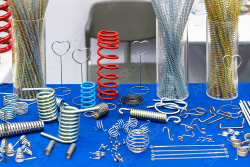 various type metal spring such as extension compressing torsion clip constant force and etc. and wire bending many shape parts for machine or other on table