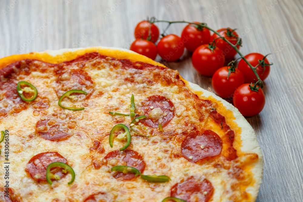 pizza with salami, mozarella, green hot pepper pizza with salami, mozarella, green hot pepper