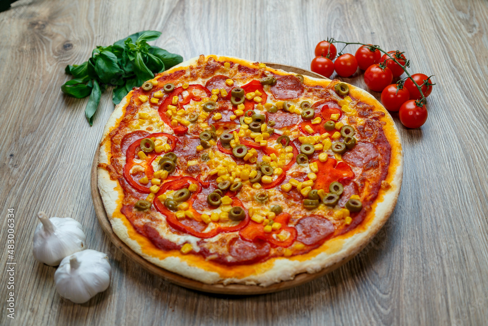 pizza with mozzarella, green olive, salami, corn and red pepper
