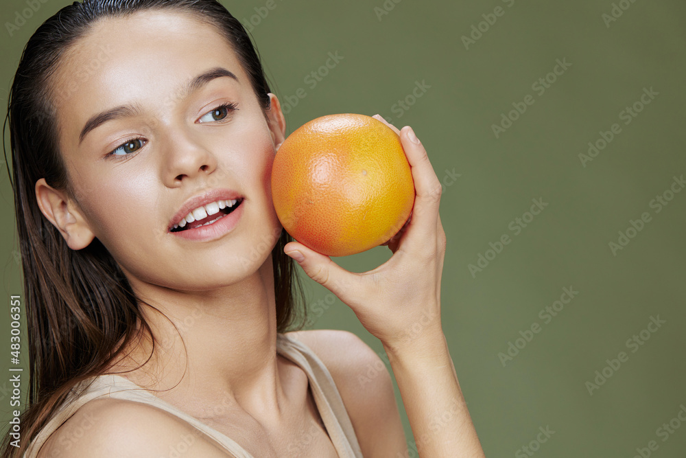 brunette eating grapefruit in hands smile vitamins diet green background brunette eating grapefruit in hands smile vitamins diet green background