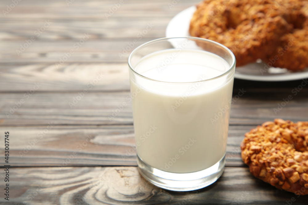 Peanut cookies on cutting board with milk on brown wooden background. Vertical photo. Peanut cookies on cutting board with milk on brown wooden background. Vertical photo.