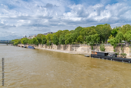 Paris, houseboats and buildings on the Seine, with the Grenelle bridge in background 