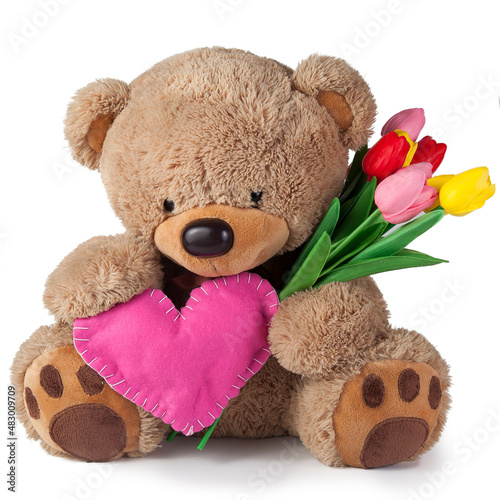 Toy teddy bear gives gifts on a white background