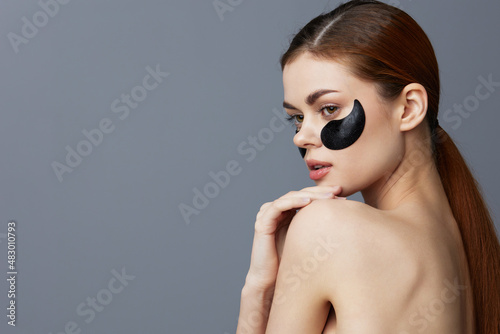 beautiful woman face black patches posing isolated background © SHOTPRIME STUDIO