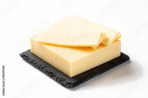 Russian cheese slicing on a white background for insulation. Classic cheese on a stone board
