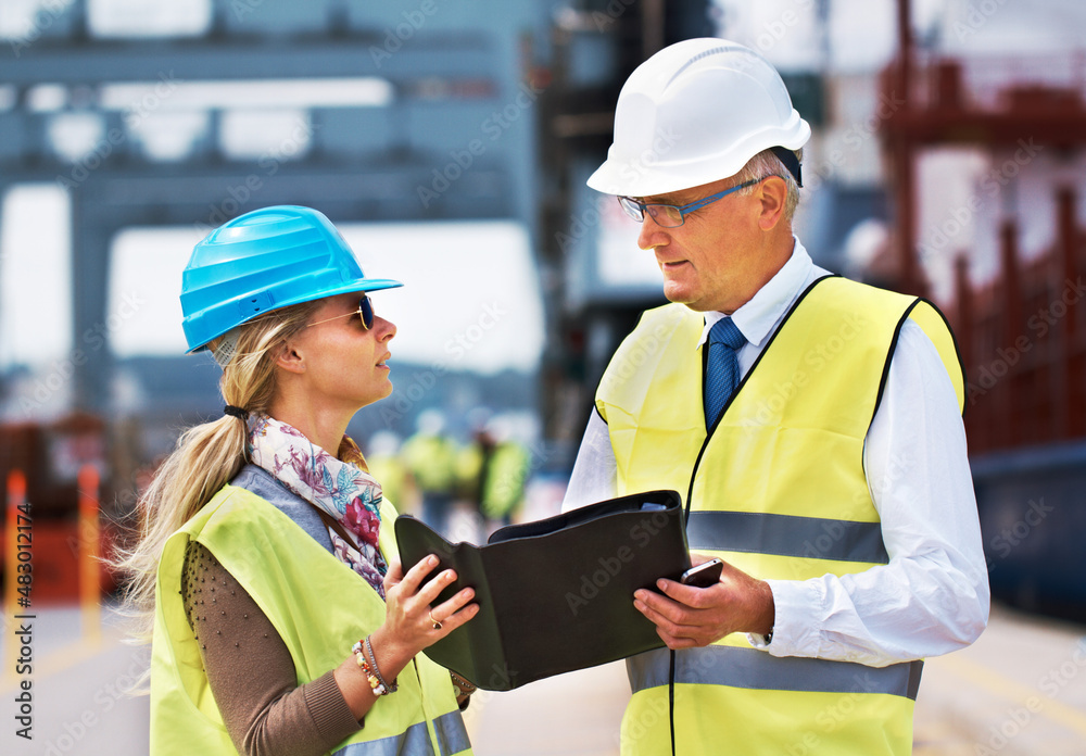 Working together creates success. Two work colleagues standing in a harbor and discussing work... Working together creates success. Two work colleagues standing in a harbor and discussing work...
