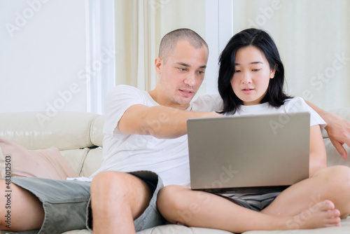 Young couple enjoying leisure time with laptop
