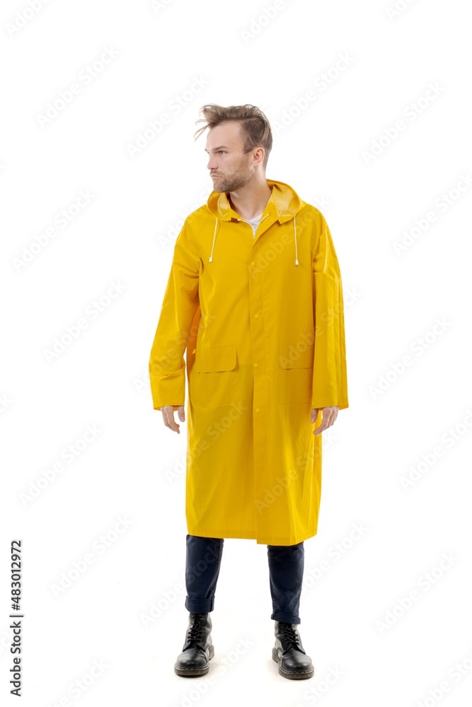 A middle-aged white man wearing a yellow raincoat standing over isolated white background looks happy. Worker concept.