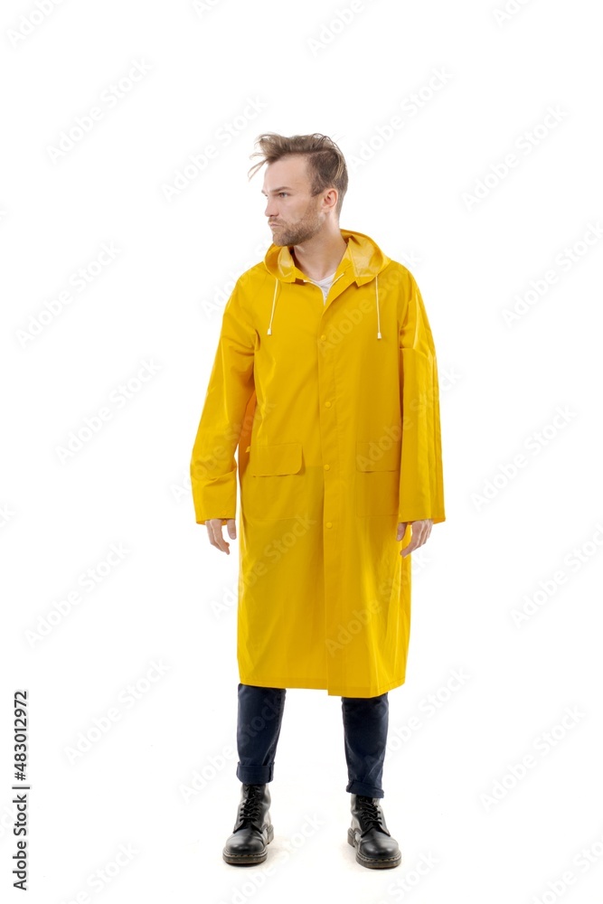 Fototapeta premium A middle-aged white man wearing a yellow raincoat standing over isolated white background looks happy. Worker concept.