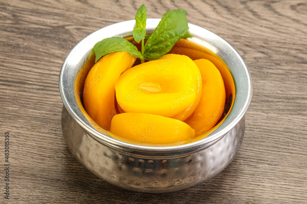 Sweet ripe canned peaches with mint