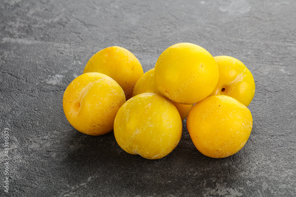 Ripe sweet yellow plum heap over background Ripe sweet yellow plum heap over background
