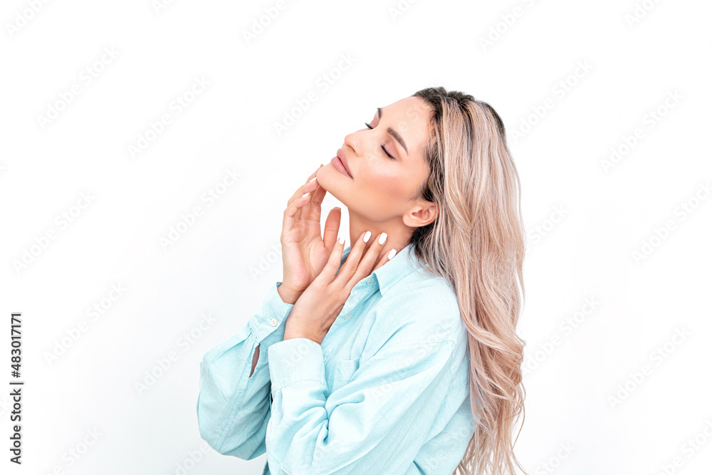 Portrait of a beautiful blonde with natural makeup on a white background. Profile. Studio shot. Portrait of a beautiful blonde with natural makeup on a white background. Profile. Studio shot.