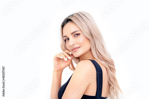 Portrait of a beautiful blonde woman with natural makeup on a white background. Studio shot.