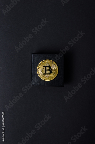 a bitcoin bitcoin on a dark background. minimalistic composition. Concept gift . Copy space