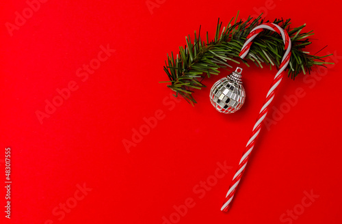 Caramel cane with Christmas and New Year decorations top view . space for text