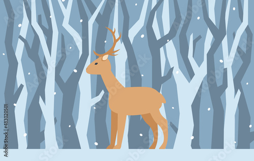 Deer on the background of tree trunks. Winter landscape with a deer.