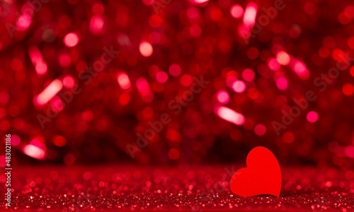Valentine's Day. Romantic image in red tones, heart on bokeh background
